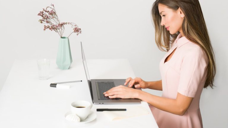 woman sitting while using laptop