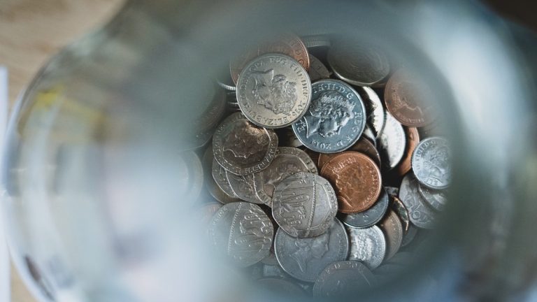 silver round coins on blue round container