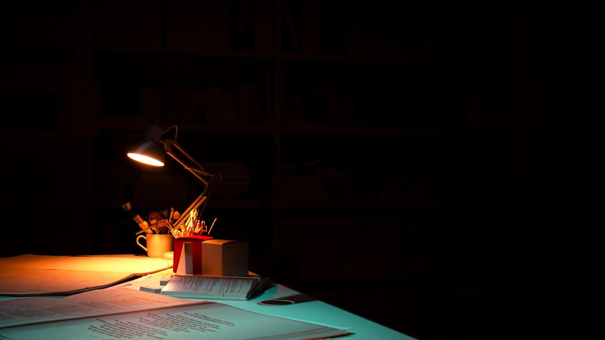 A table with a lit candle on top of it