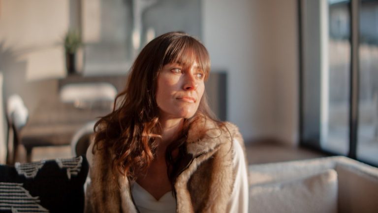 a woman sitting on a couch in a living r